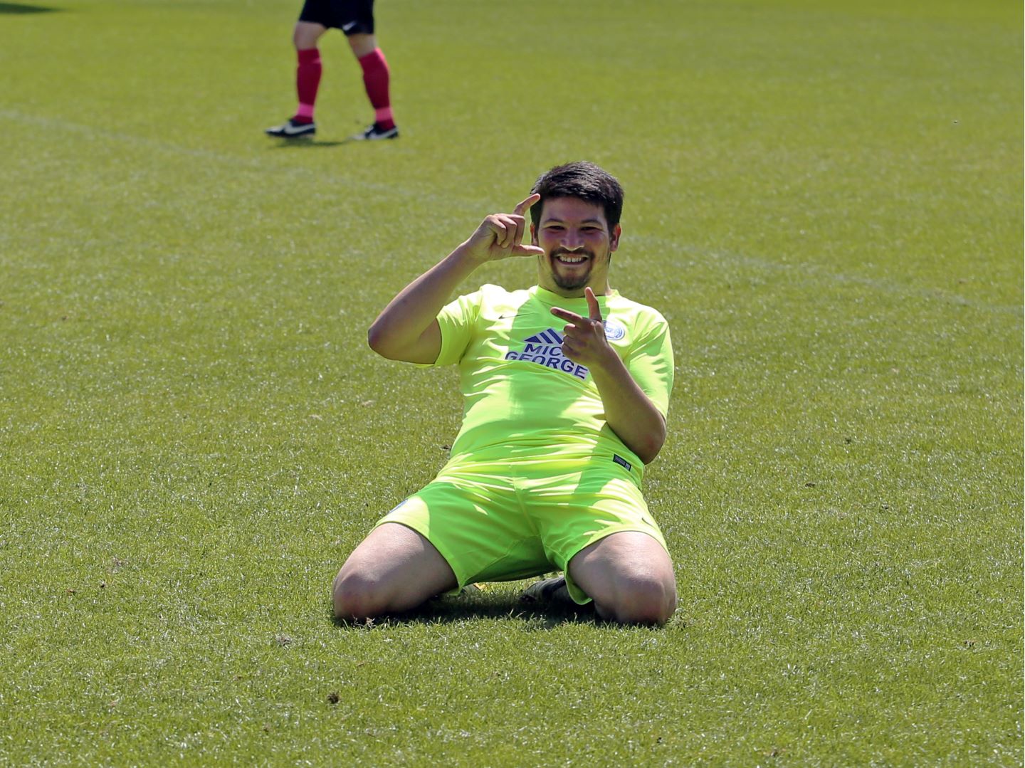 Club Photographer Joe Dent celebrates his goal with a "camera" knee slide